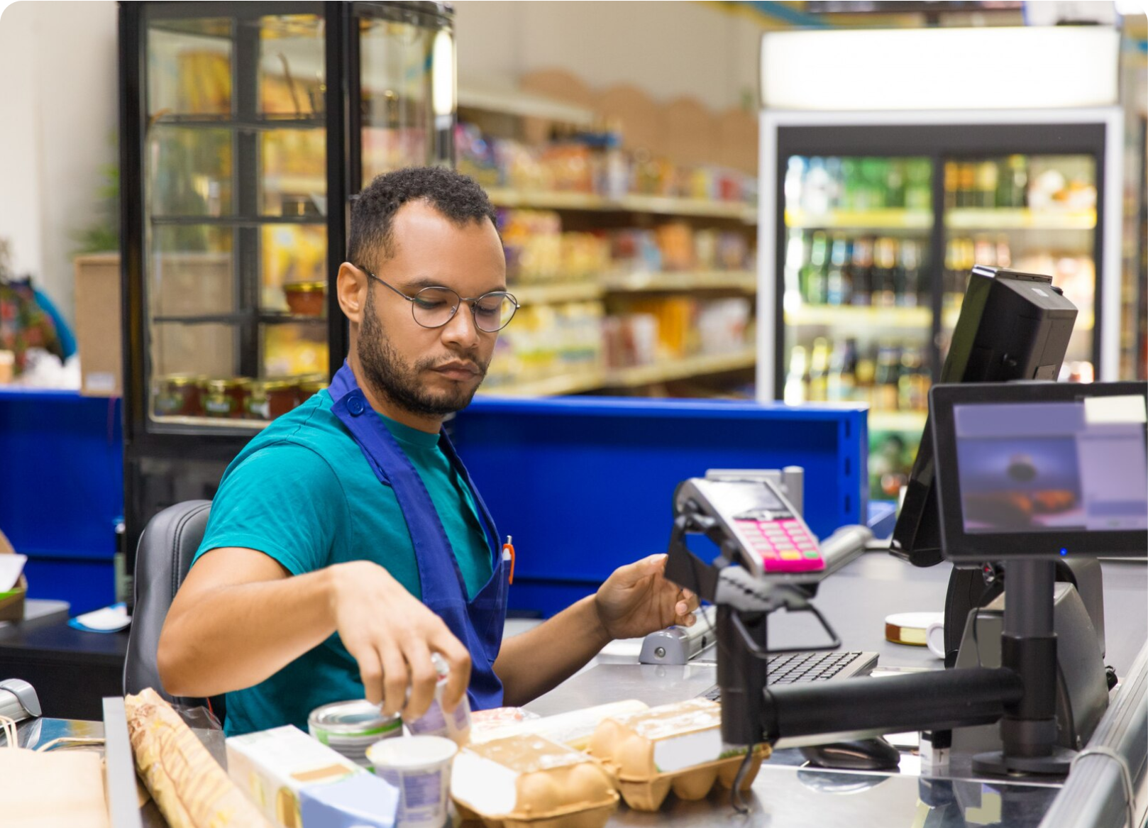 Cashier processing a card payment at a retail store checkout