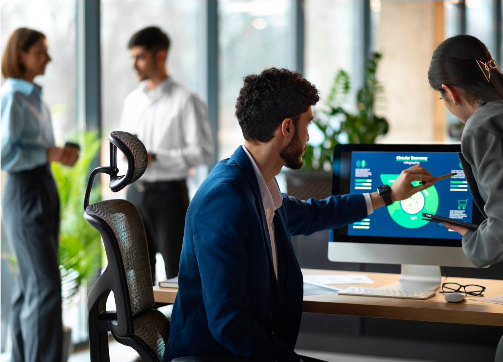 Team reviewing analytics on a monitor in a modern office