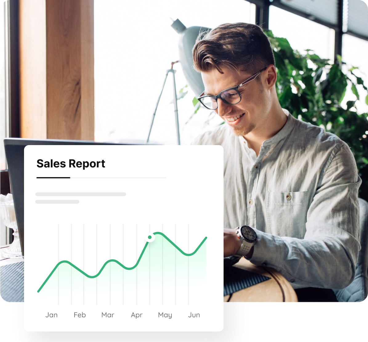 Business owner reviewing a rising sales report chart on a laptop