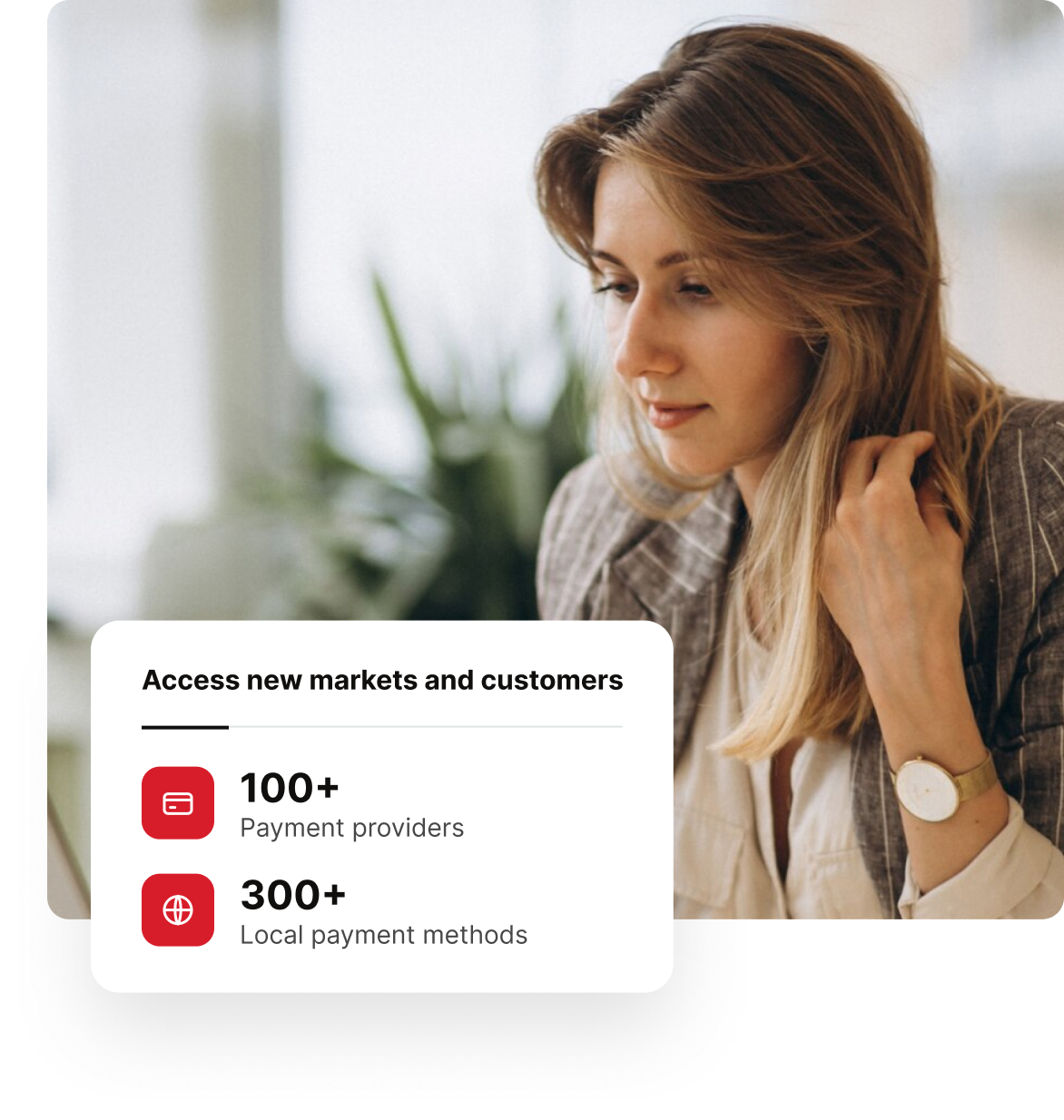 Businesswoman working on a laptop, with a card showing access to new markets and customers: 100+ payment providers and 300+ local payment methods